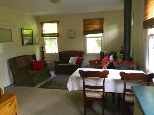 a living room with a table and a couch at Alexandra Farmstay in Alexandra