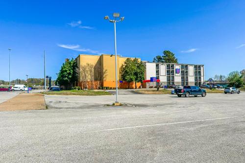 an empty parking lot with a building and a street light at Jackson Hotel And Convention Center in Jackson