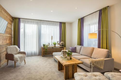 a living room with a couch and a table at Landhotel Gockelwirt in Eisenberg