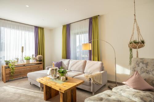 a living room with a couch and a table at Landhotel Gockelwirt in Eisenberg