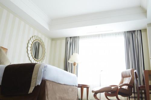 a hotel room with a bed and a window at Imperial Hotel Osaka in Osaka
