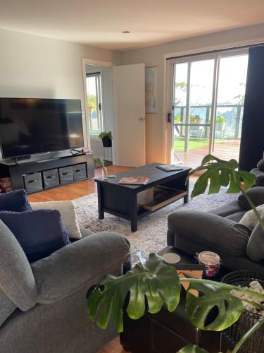 a living room with a couch and a table at The Sounds in Murdunna