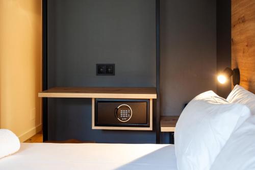 a room with a bed and a tv on a table at Plaza Obradoiro Express by Bossh! Hotels in Santiago de Compostela