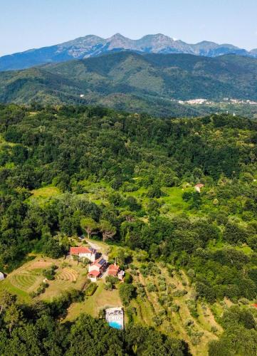 an aerial view of a farm with mountains in the background at Agripodere Il Falco in Pontremoli