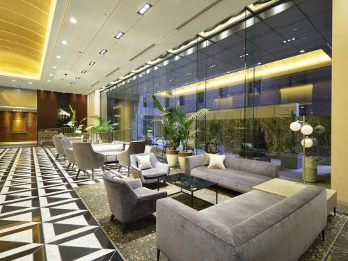a lobby with couches and chairs and a table at Hotel Villa Fontaine Grand Tokyo-Roppongi in Tokyo