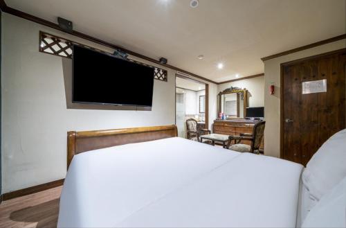 a bedroom with a bed and a flat screen tv at 케일라호텔 in Uijeongbu