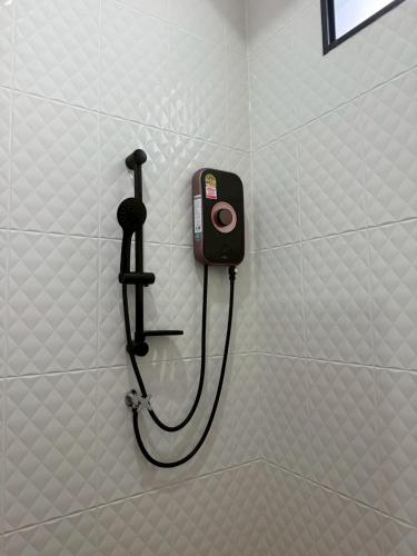 a shower hose attached to a wall in a bathroom at Krabi Mantra Pool Villa in Ao Nang 