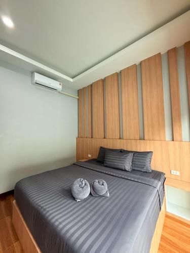 a bedroom with a large bed with two towels on it at Krabi Mantra Pool Villa in Ao Nang 