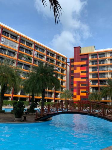 a bridge over a swimming pool in front of a building at СС619 Романтика, чудесный вид и домашний уют in Mai Khao Beach