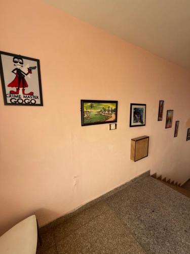 a corner of a room with pictures on a wall at Cedar Valley Retreat in Jagatsukh