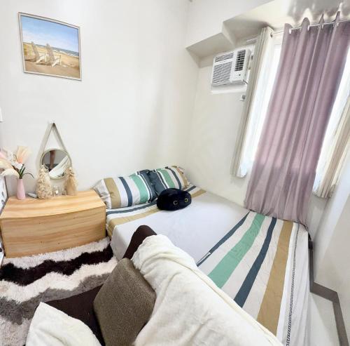 a bedroom with two beds and a window at Maiko Happy Studio near US Embassy in Manila
