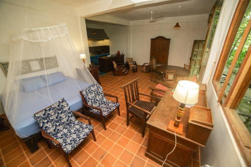 a room with a bed and a table and chairs at The Kandy Samadhicentre in Kandy
