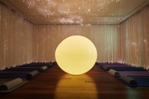 a room with a large white ball on the wall at WE Hotel Jeju in Seogwipo