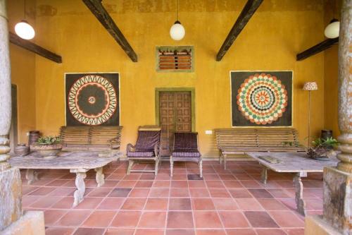 a room with benches and paintings on the wall at The Kandy Samadhicentre in Kandy