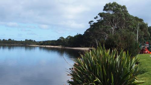 a view of a body of water with trees at Strahan Retreat Holiday Park in Strahan