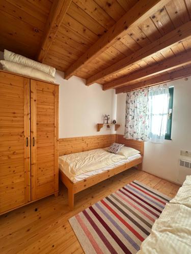 a bedroom with a bed and a window and a rug at Chatka 428 a 429 - Tatralandia in Liptovský Mikuláš