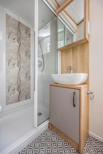 a bathroom with a sink and a shower at Charming Home in Lakeside Park - Pass The Keys in Chichester