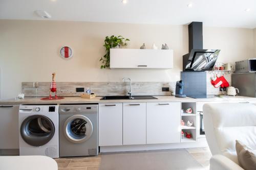 a kitchen with a washing machine and a sink at Gite le Pic Epeiche in Sarlat-la-Canéda