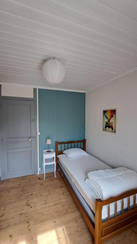 une chambre avec deux lits et une table avec une lampe dans l'établissement Maison Bretonne, à La Boussac
