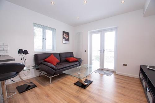 a living room with a couch and a glass table at Affleck Retreat 5 - SJA Stays - Modern 1 Bed Apartment in Aberdeen