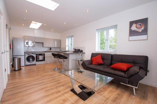 a living room with a couch and a glass table at Affleck Retreat 5 - SJA Stays - Modern 1 Bed Apartment in Aberdeen