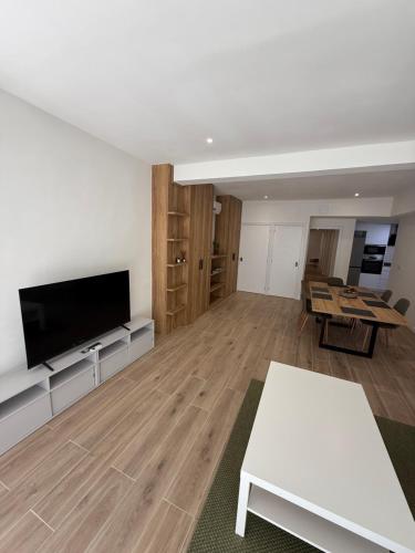 a living room with a flat screen tv and a table at Casa Dolce Casa in Valencia