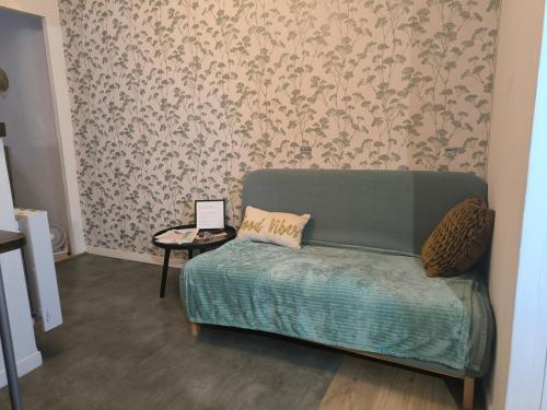 a living room with a couch and a table at La Golondrina in Villefranche-sur-Saône