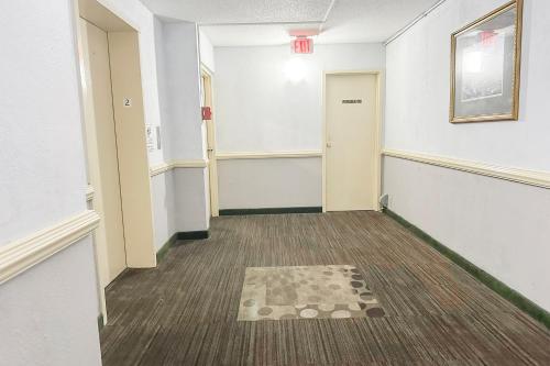 an empty hallway with a rug on the floor at Jackson Hotel And Convention Center in Jackson