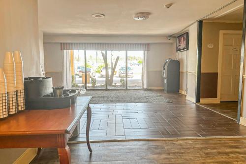 a living room with a kitchen with a refrigerator at Jackson Hotel And Convention Center in Jackson