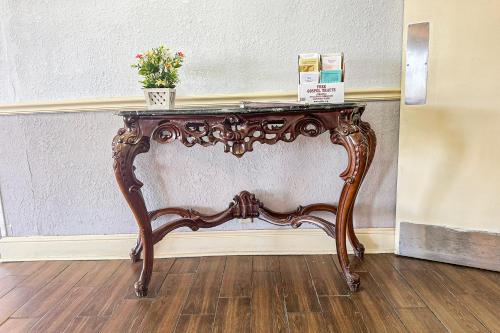 a console table with a potted plant on top of it at Jackson Hotel And Convention Center in Jackson