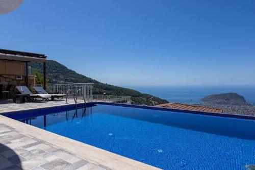 a swimming pool with a view of the ocean at Qoople Villa Tepe with infinity pool and panoramic view in Alanya
