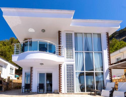 a white house with a view of the ocean at Qoople Villa Tepe with infinity pool and panoramic view in Alanya