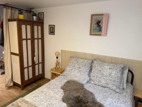a bedroom with a bed with a dog laying on it at Chambre pour 2 personnes, forêt, piscine in Arbonne-la-Foret
