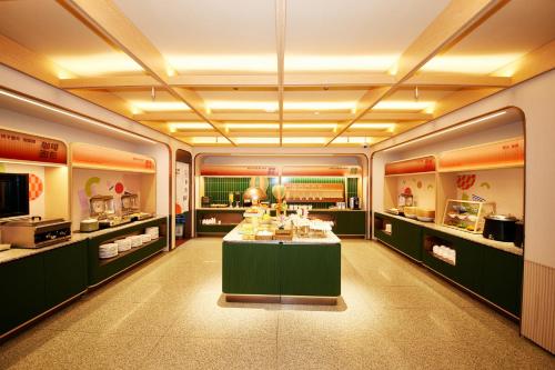 a room with a table with food on it at Orange Hotel Shanghai Hongkou Football Stadium Branch in Shanghai