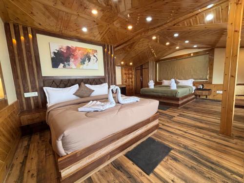 a bedroom with a large bed in a cabin at Attic cozy retreat by high rise inn kufri in Kūfrī