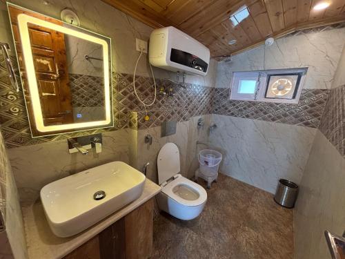 a small bathroom with a sink and a toilet at Attic cozy retreat by high rise inn kufri in Kūfrī