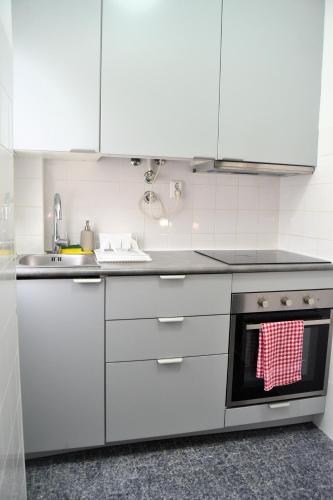 a kitchen with white cabinets and an oven at JAM Retreat in Lisbon