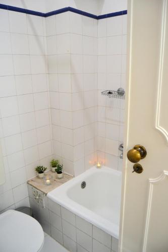 a bathroom with a bath tub and a toilet at JAM Retreat in Lisbon