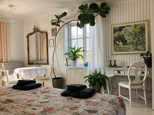 a bedroom with a bed with two pillows on it at B&B Österlens RosenTrädgård in Glemmingebro
