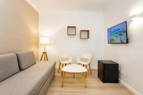 a living room with a couch and a table and chairs at Minura Sur Menorca in Punta Prima