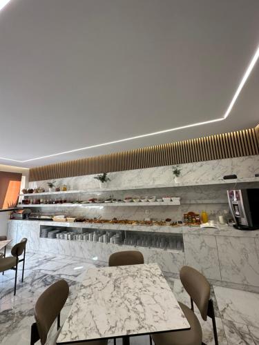a restaurant with two tables and chairs and a counter at VagAthan - Lux Holidays in Afitos