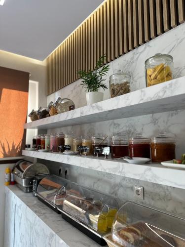 a kitchen with shelves filled with jars of food at VagAthan - Lux Holidays in Afitos