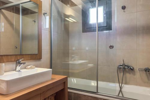 a bathroom with a sink and a shower at YaChara Villa in Kissamos
