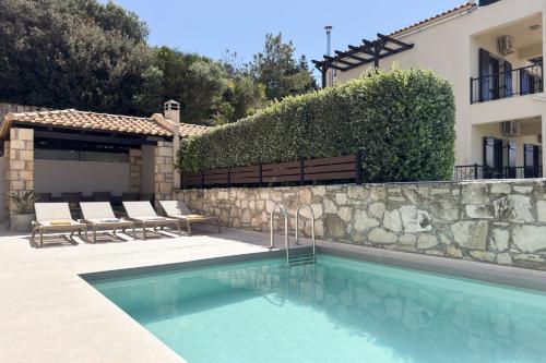 a swimming pool in front of a house at YaChara Villa in Kissamos