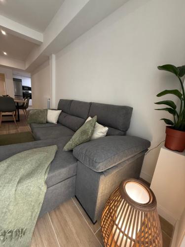 a living room with a gray couch and a table at Casa Dolce Casa in Valencia