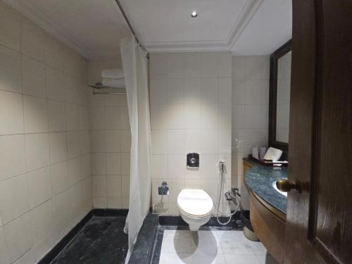 a bathroom with a toilet and a sink at Hotel Supreme Suites I B2B Friendly I Ludhiana in Ludhiana