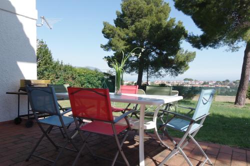 a table and chairs with a vase on it at La Casa di Betta in Marcelli