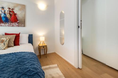 a bedroom with a bed and a white wall at Magnificent apartment on Lake Lugano, Morcote in Morcote
