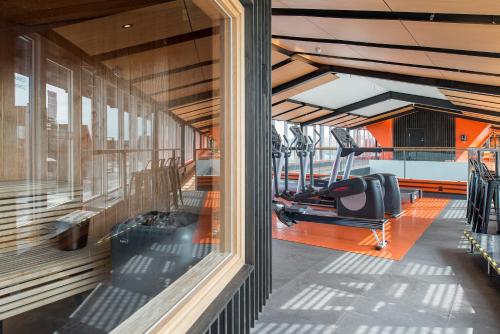 a view of a gym with a treadmill and a chair at Quality Hotel 11 & Eriksbergshallen in Gothenburg