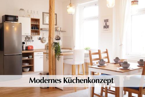 a kitchen and dining room with a stainless steel refrigerator at Helles Altbau-Loft mit Kingsize Bett, Smart-TV, etc in Erfurt